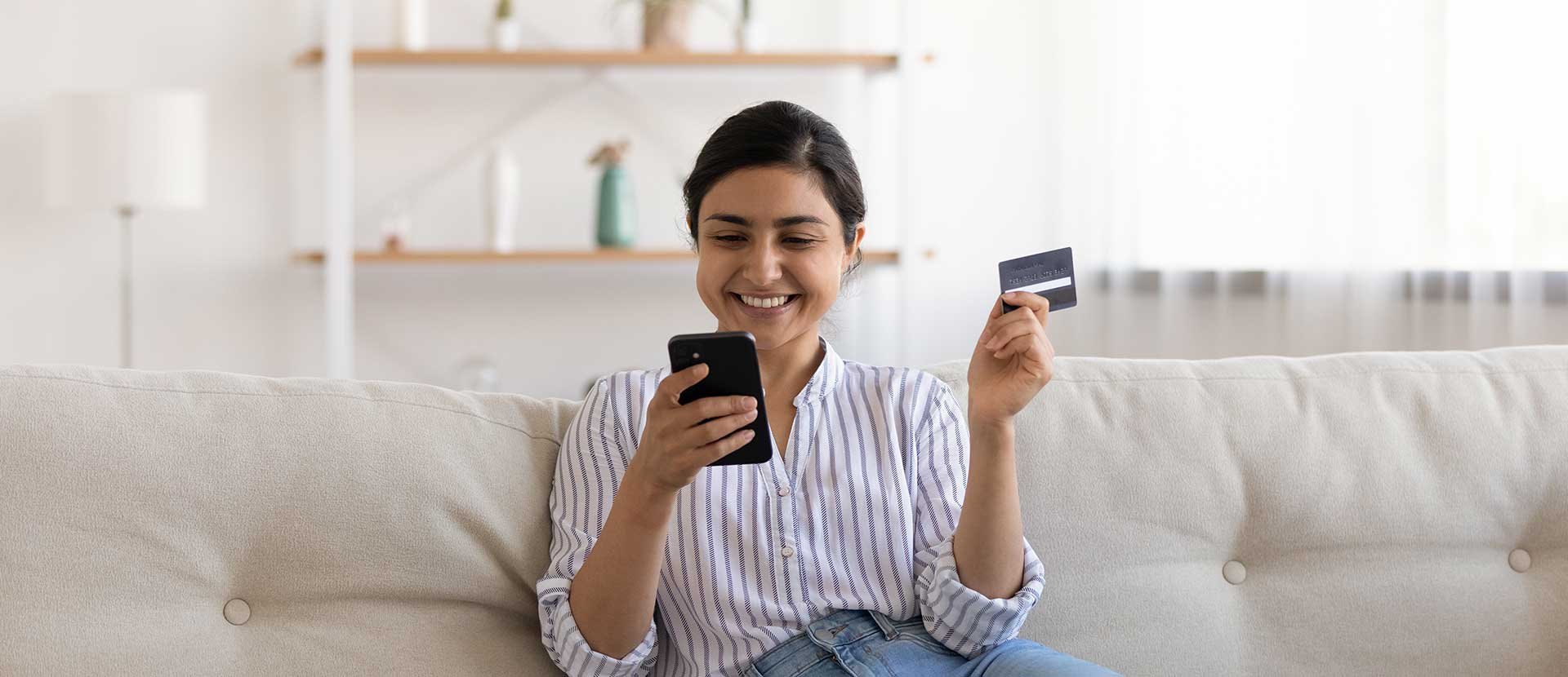 Woman on phone using card controls to control her debit card